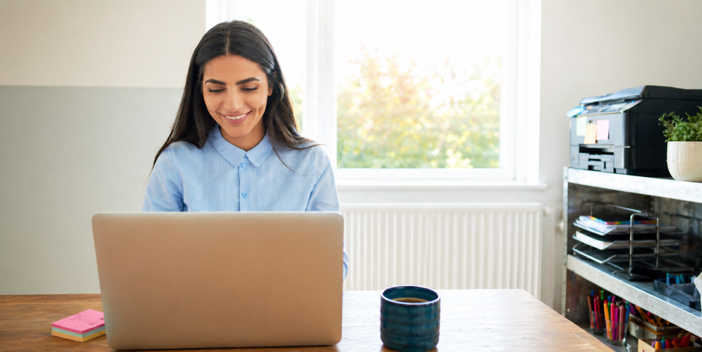 adviser smiling at her laptop