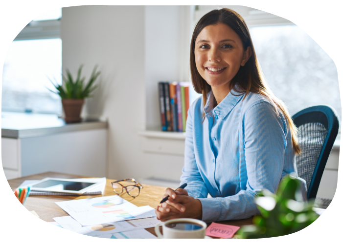 imgae of female adviser at a desk, smiling at the camera